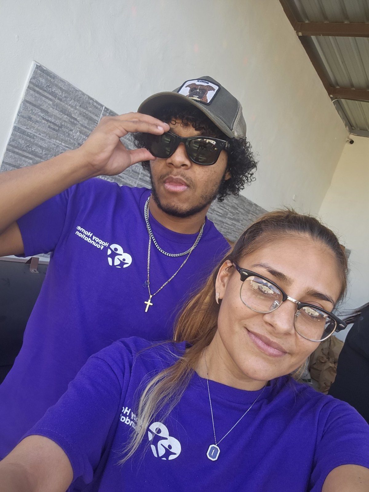 Two Happy Homes Foundation volunteers wearing purple shirts